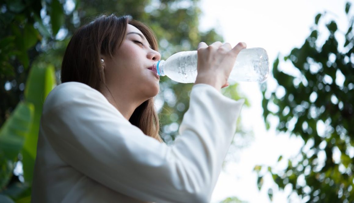 Beautiful business woman drinking water after hard work